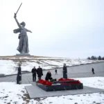 Russian President Vladimir Putin lays flowers at the memorial