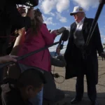 President Donald Trump speaks with reporters