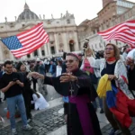 A bishop dances with a U.S. flag