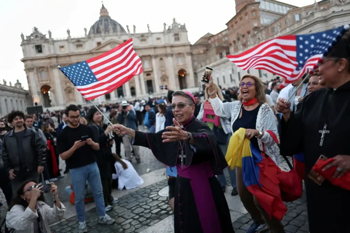 A bishop dances with a U.S. flag