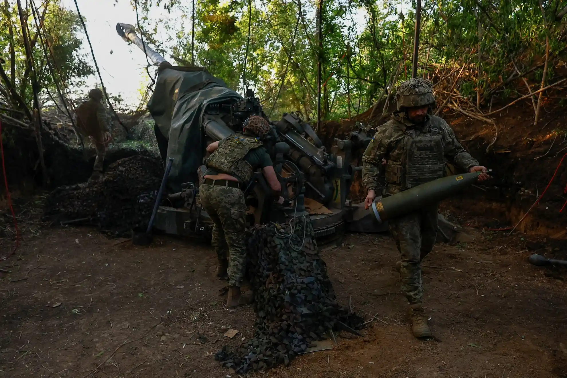 Ukrainian soldiers fire an American-made M777 Howitzer
