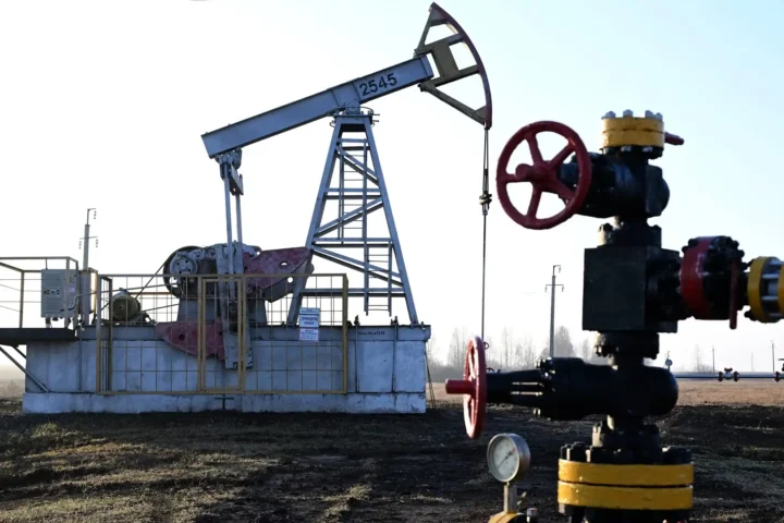 A view shows a pump jack at an oil field