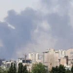 Smoke rises from the Shahran oil depot